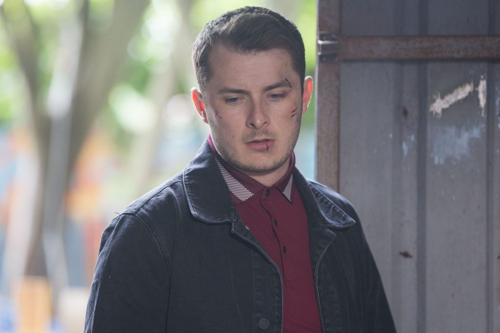 WARNING: Embargoed for publication until 00:00:01 on 02/08/2019 - Programme Name: EastEnders - July - September - 2019 - TX: 01/08/2019 - Episode: EastEnders - July - September - 2019 - 5964 (No. 5964) - Picture Shows: *NOT FOR USE PRE-TX WITHOUT PRIOR APPROVAL* Ben finds Phil injured and surprises Kat, Martin and Stacey, Ben Mitchell (MAX BOWDEN) - (C) BBC - Photographer: Jack Barnes