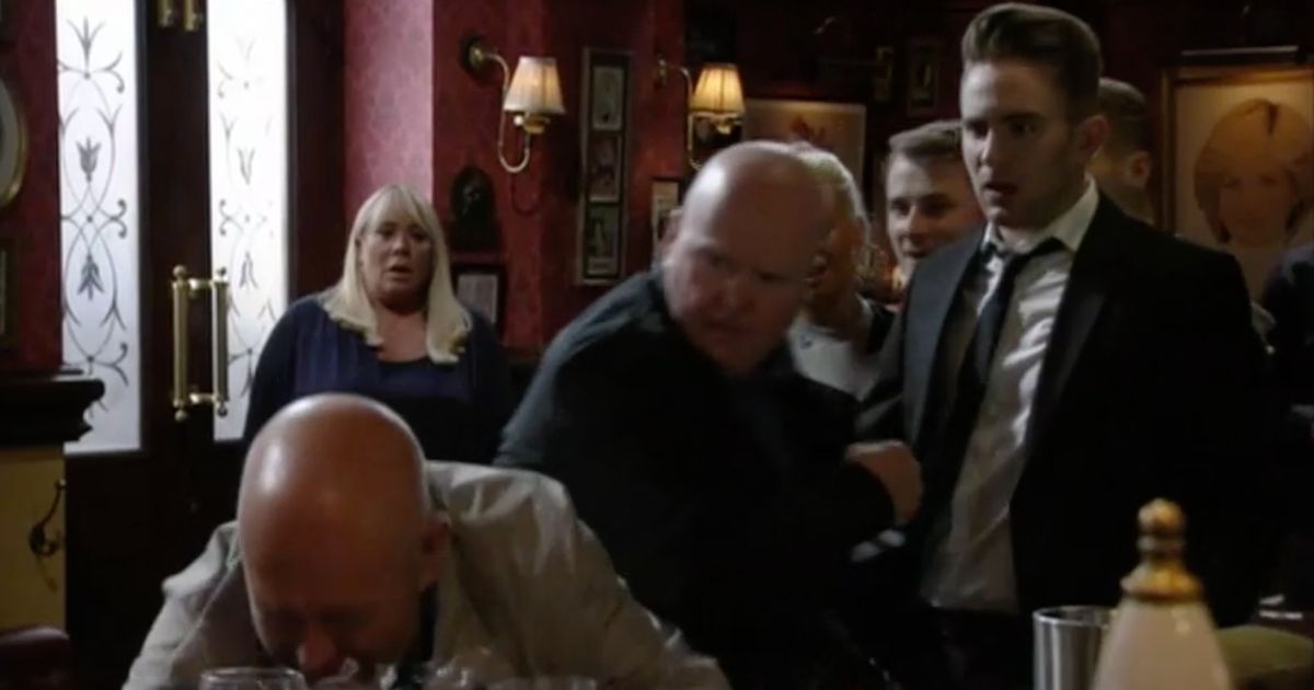 Phil punches Jonno on EastEnders