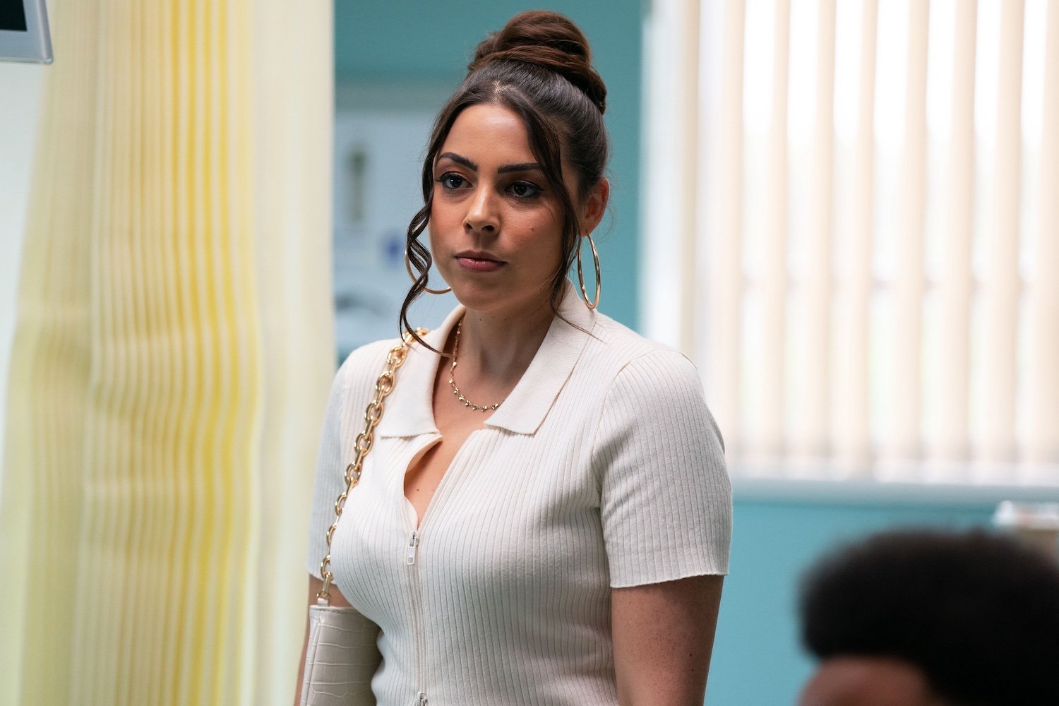 Priya on EastEnders, looking worried