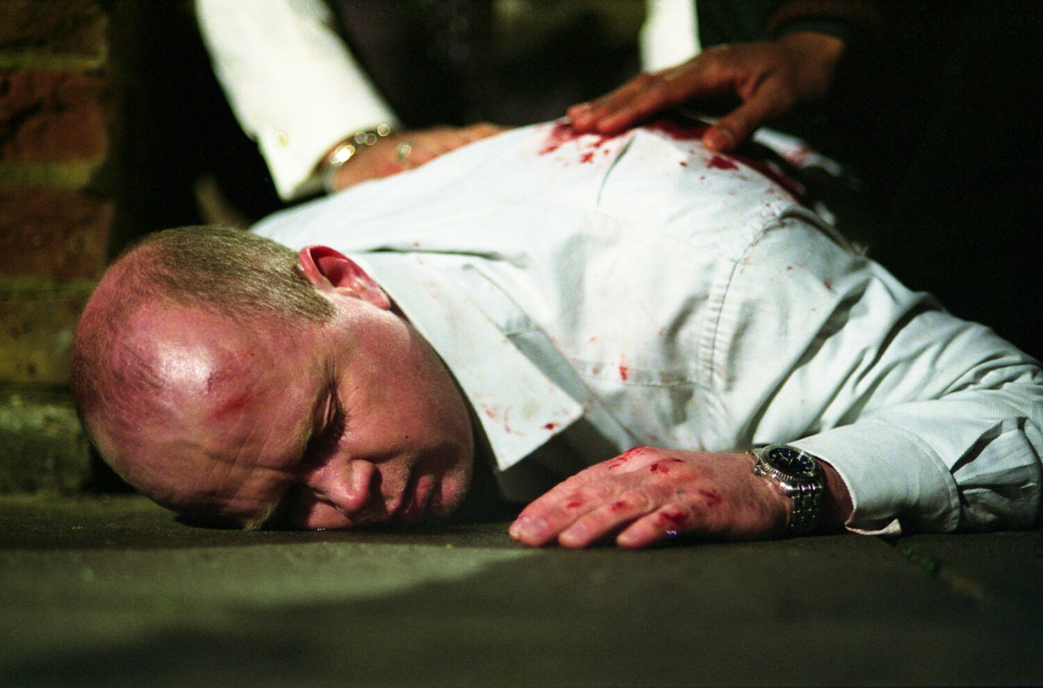Phil Mitchell lies shot on the ground (Credit: BBC)