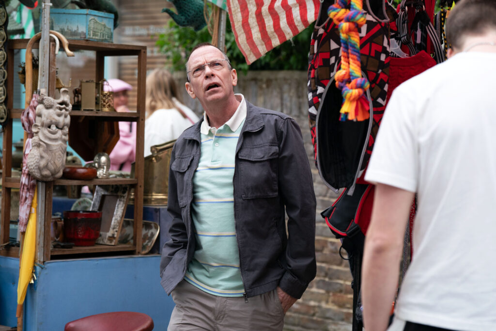 Ian stands at the fruit and veg stall on EastEnders