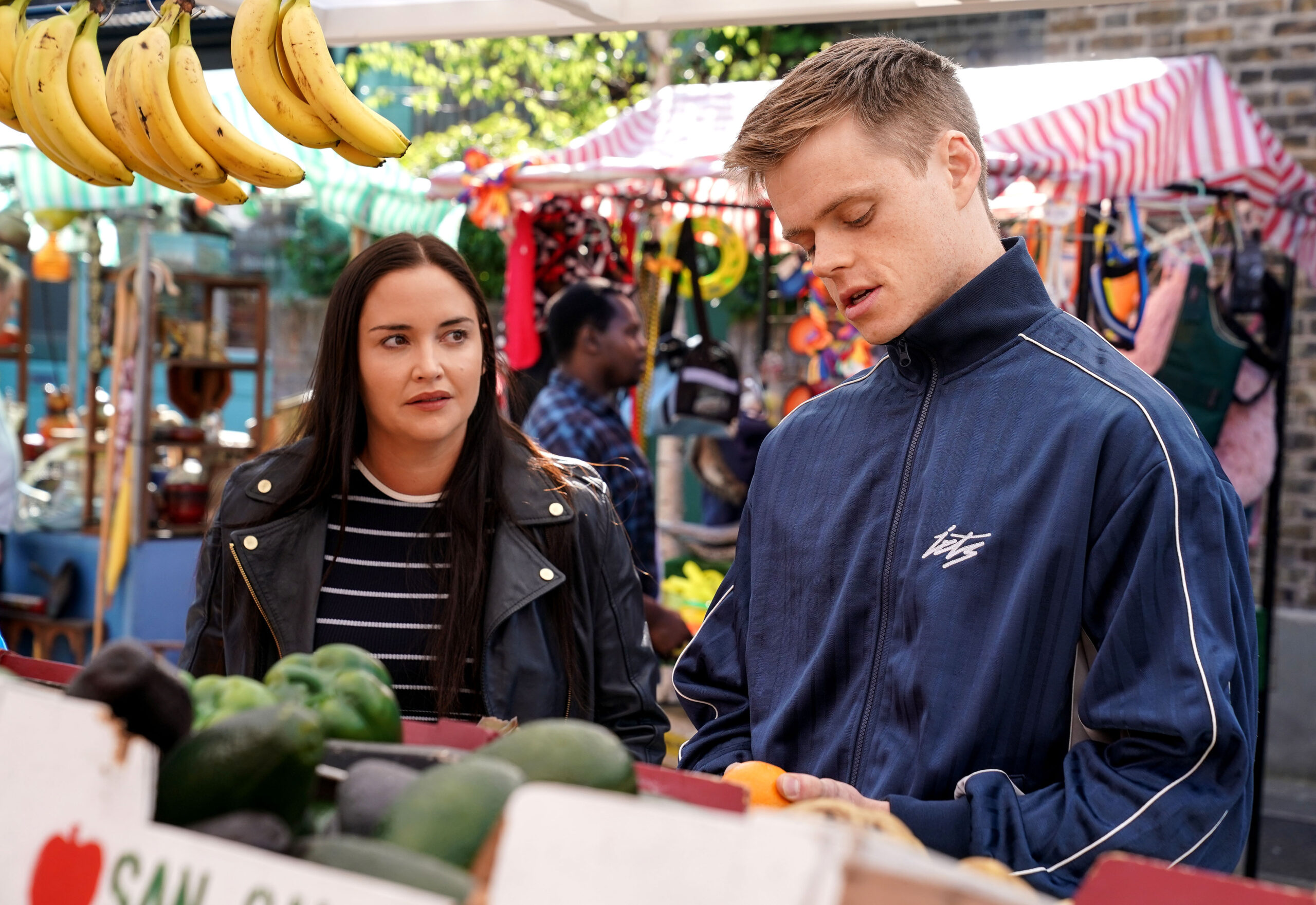 Oscar and Lauren talk on the fruit and veg stall