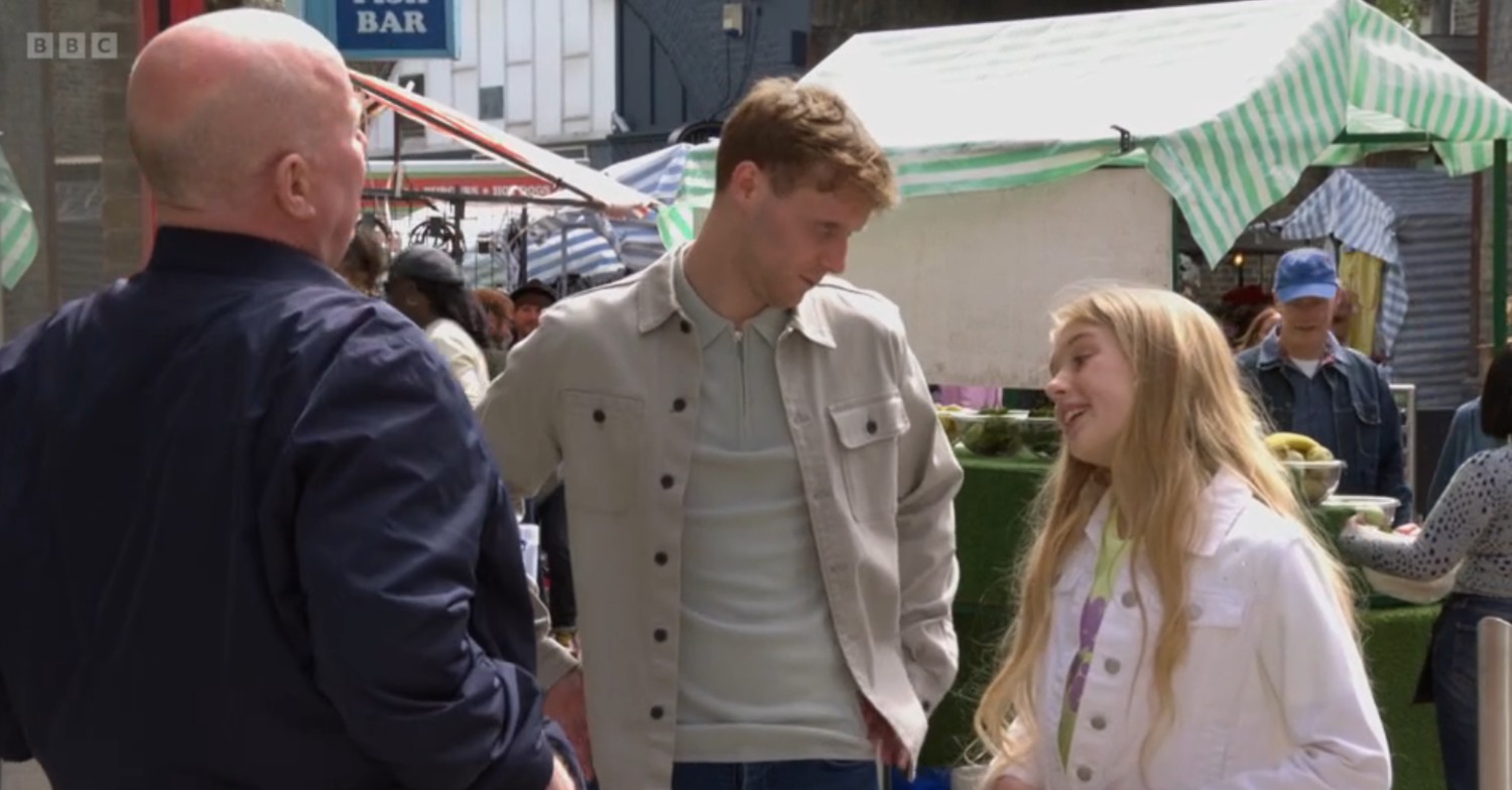 Phil looks on as Jay and Lexi talk on EastEnders