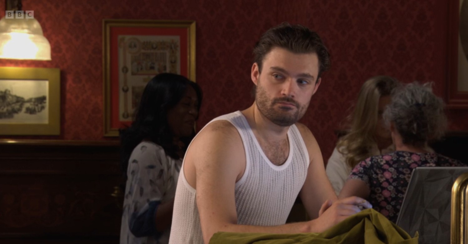 Johnny at the bar in his vest on EastEnders
