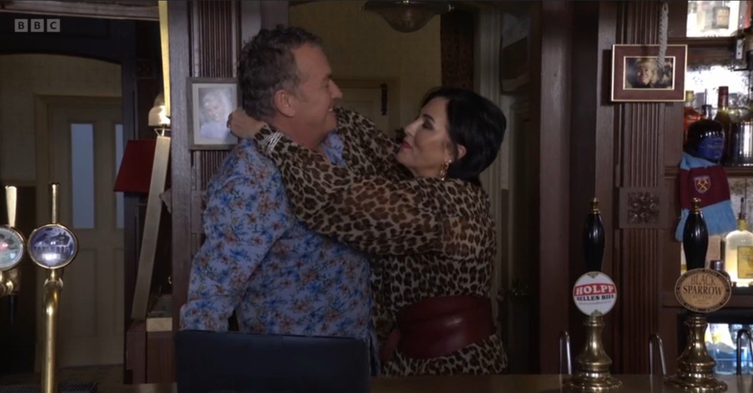 Kat and Alfie hug behind the bar of The Vic