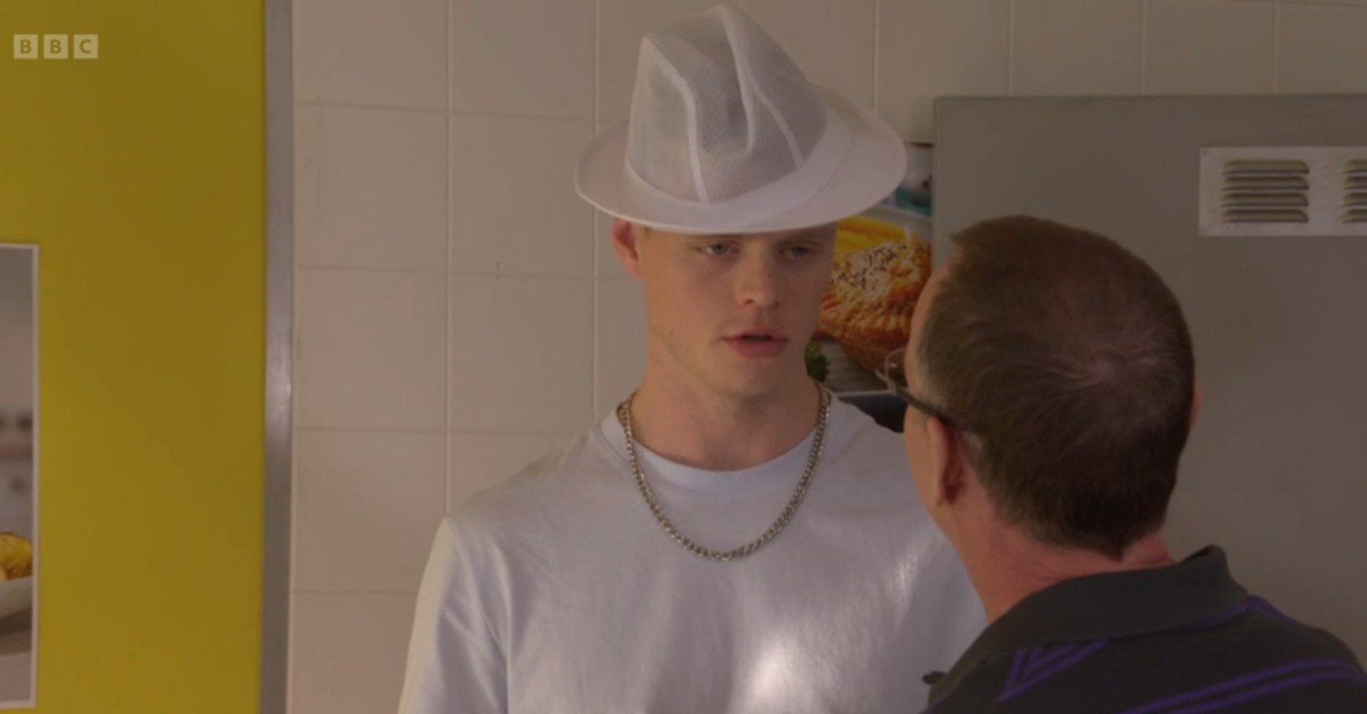 Oscar wearing the chip shop hat in the chip shop