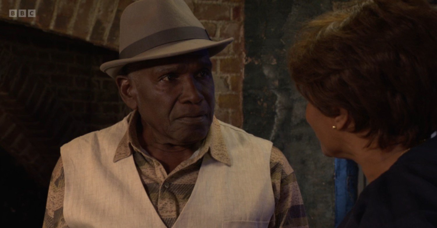 Patrick looks worried as he talks to Yolande on EastEnders
