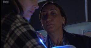 Doctor Ayub inspects baby Jimmy on EastEnders