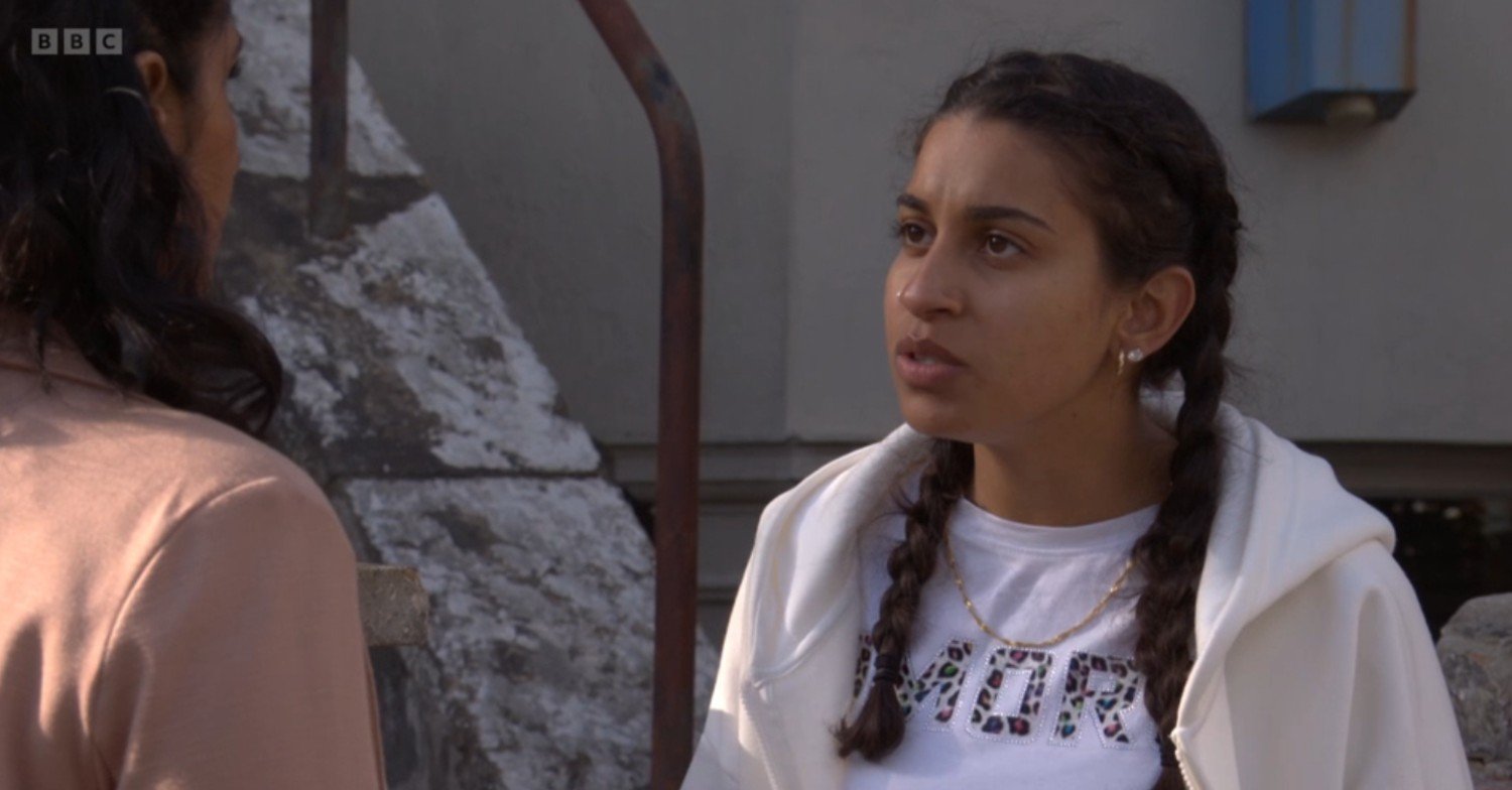 Avani looks annoyed as she talks to Suki on EastEnders