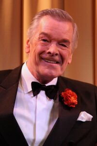 Frank Barrie smiling in a tuxedo
