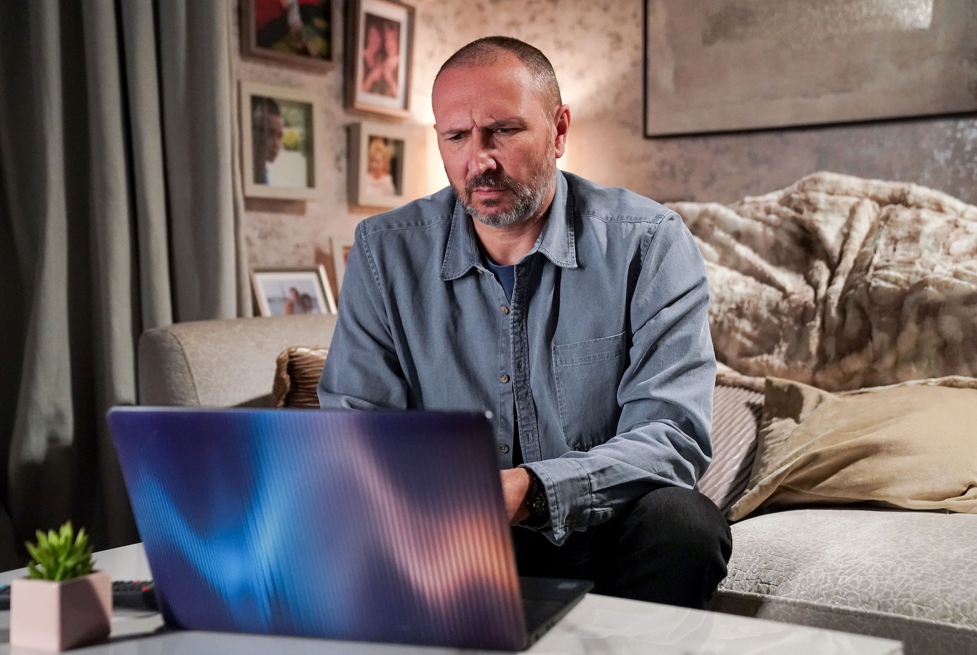 Ross looks worried as he uses Joel's laptop on EastEnders