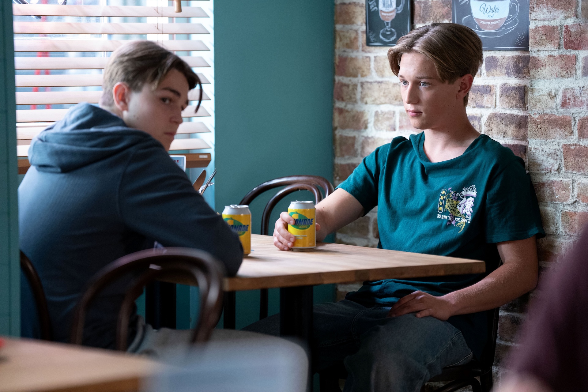Joel and Tommy talk in the cafe