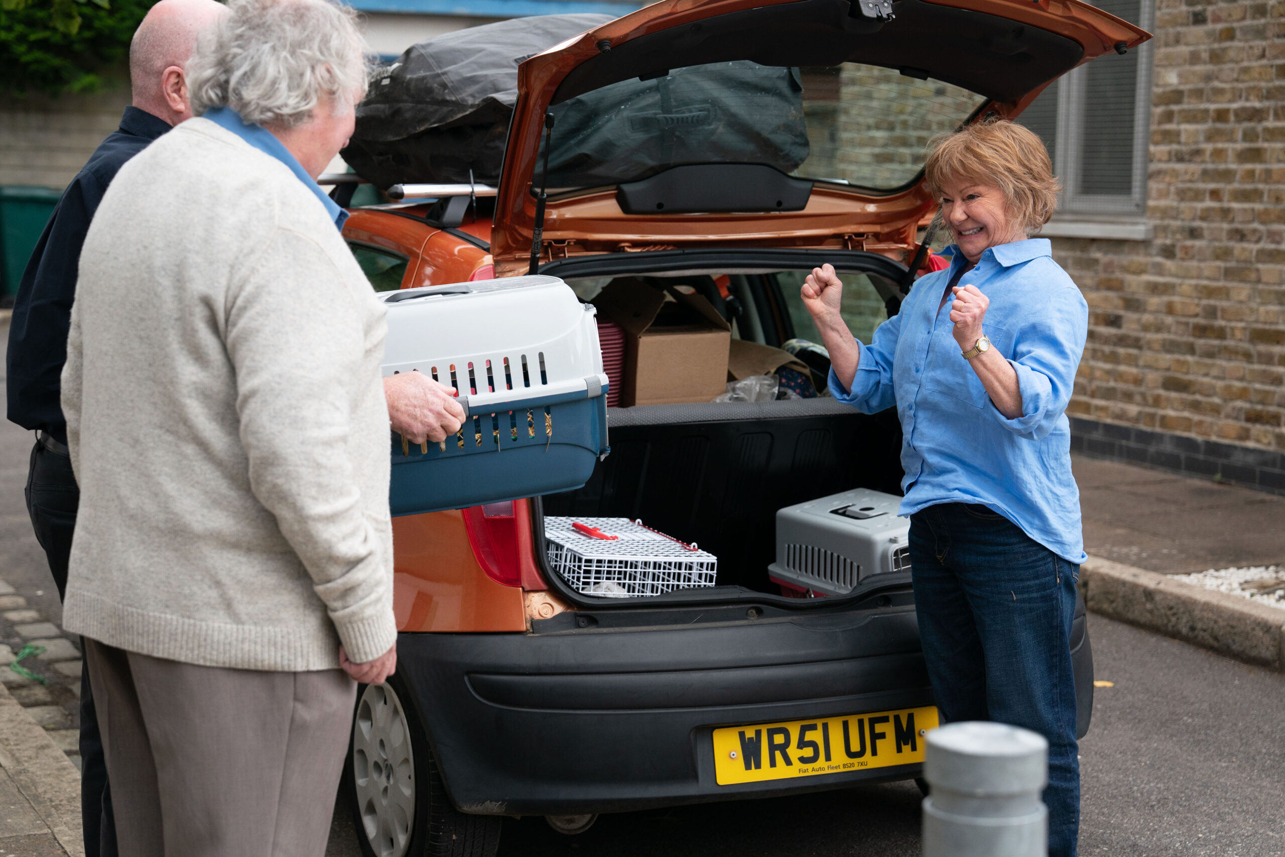 Julie looks excited as she talks to Nigel in EastEnders spoilers