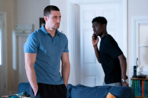 EastEnders' Harry looks miserable as Okie talks to him