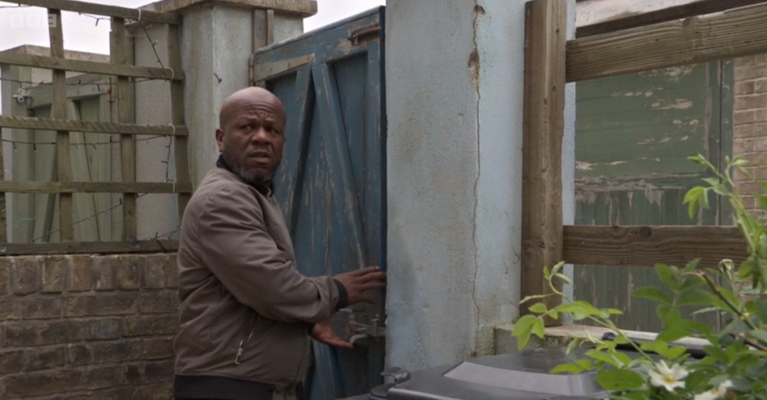 Howie sneaking into Oscar and Lauren's backyard on EastEnders