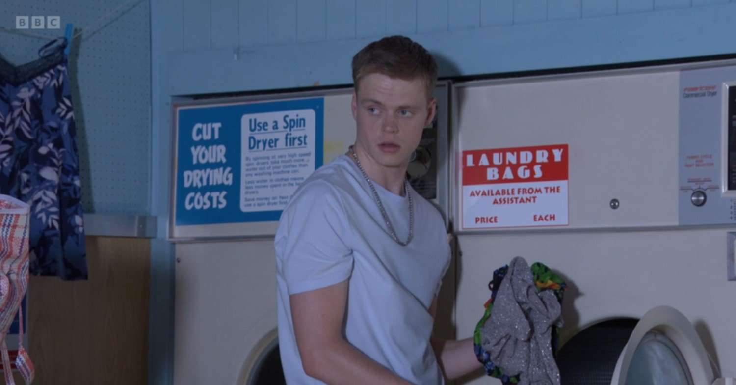Oscar looks guilty in the laundrette on EastEnders