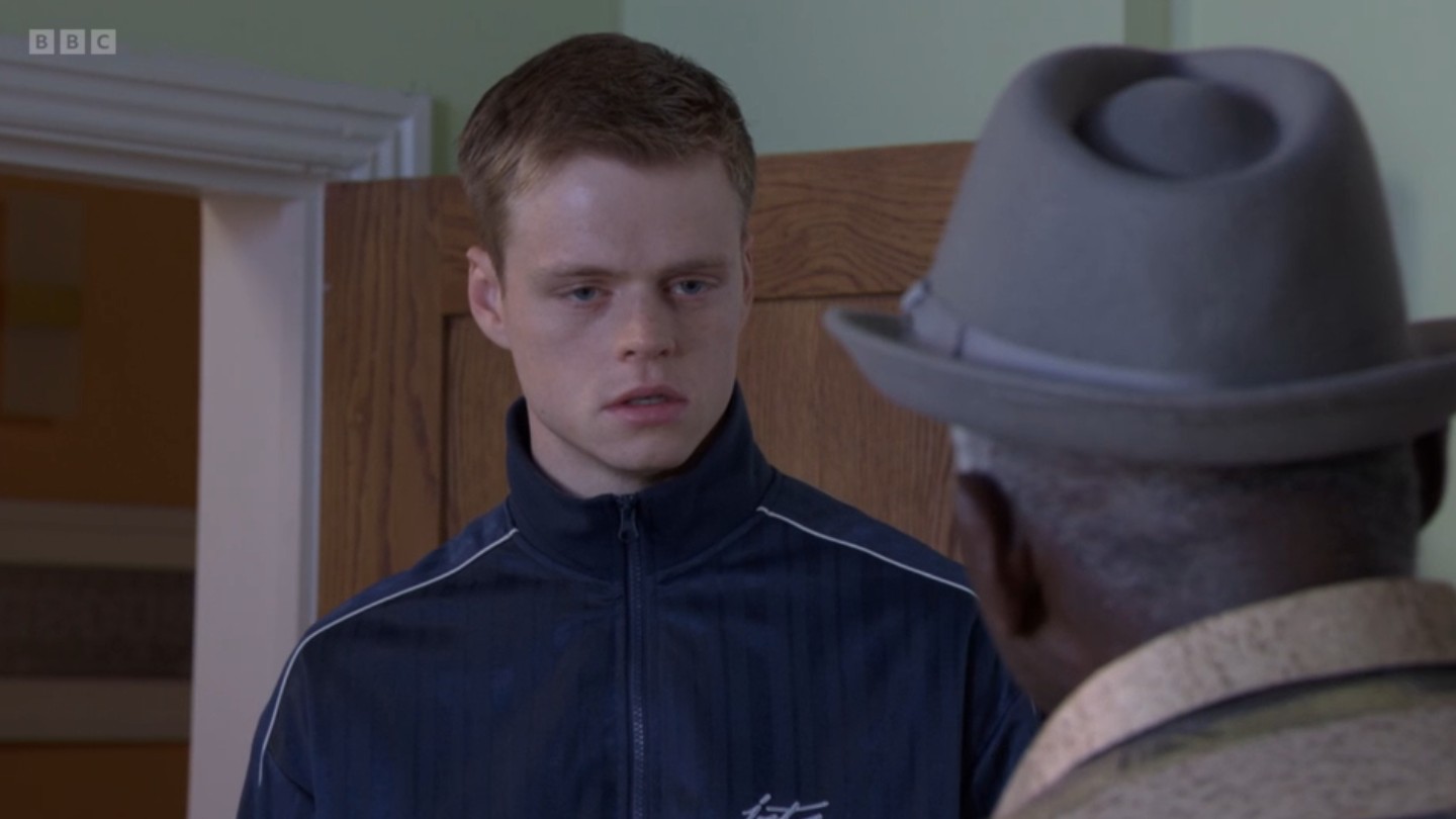 Oscar looks guilty as he talks to Patrick in EastEnders tonight