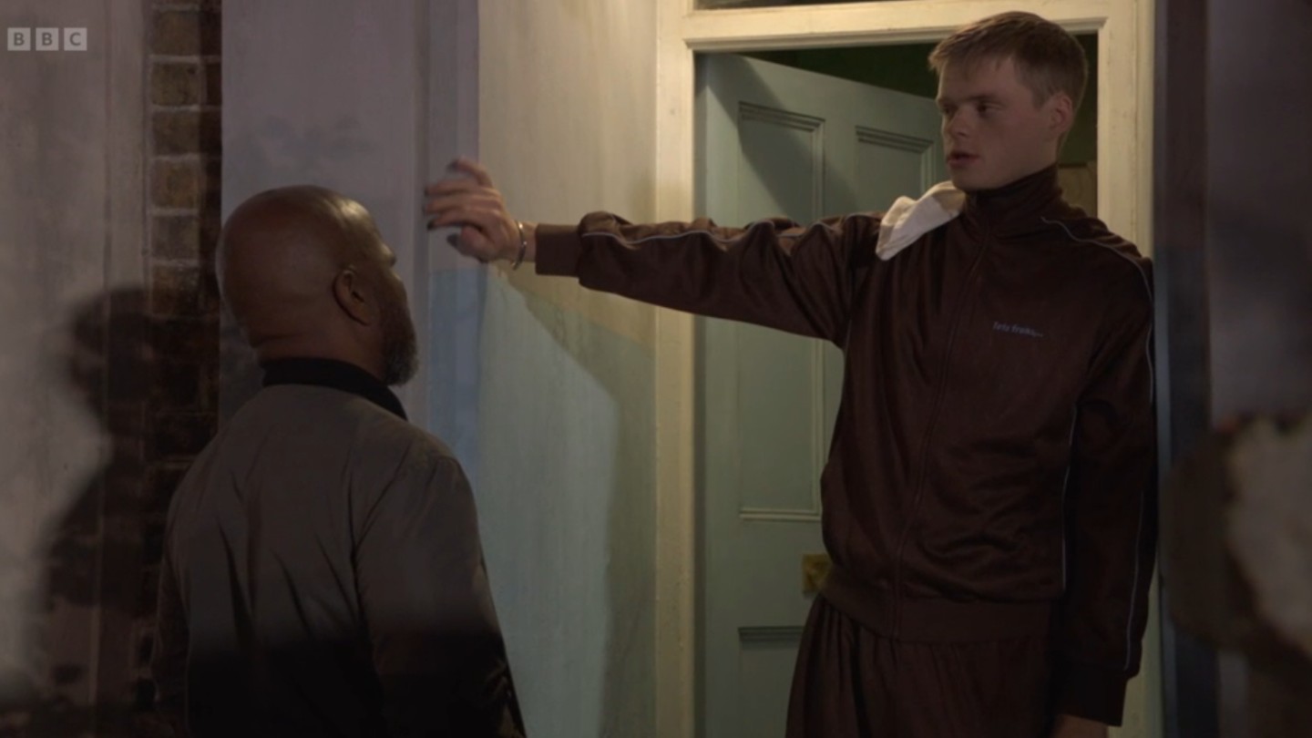Oscar looks smug as he talks to Howie on the doorstep on EastEnders tonight