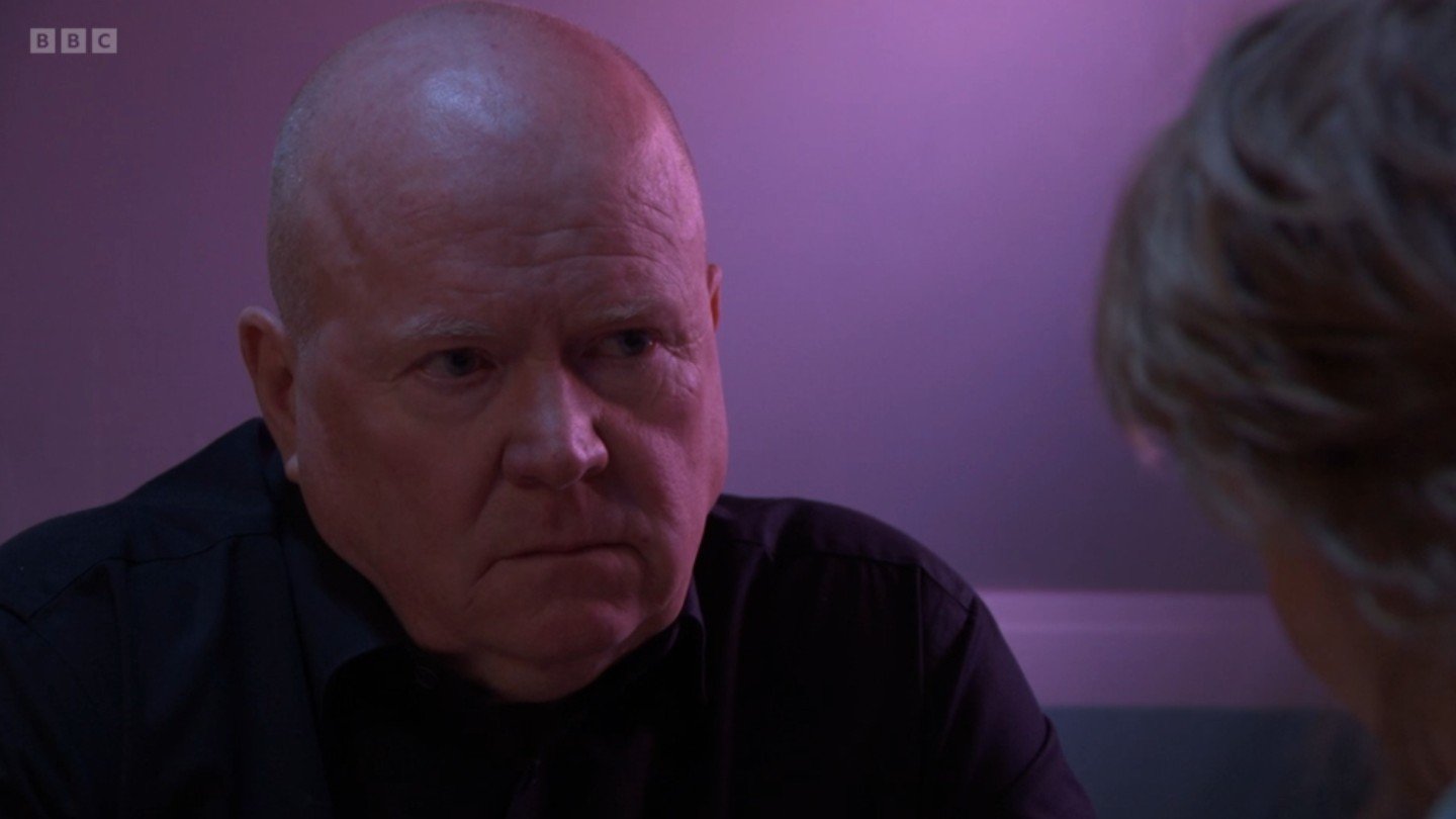 Phil looks serious as he talks to Julie in the cafe