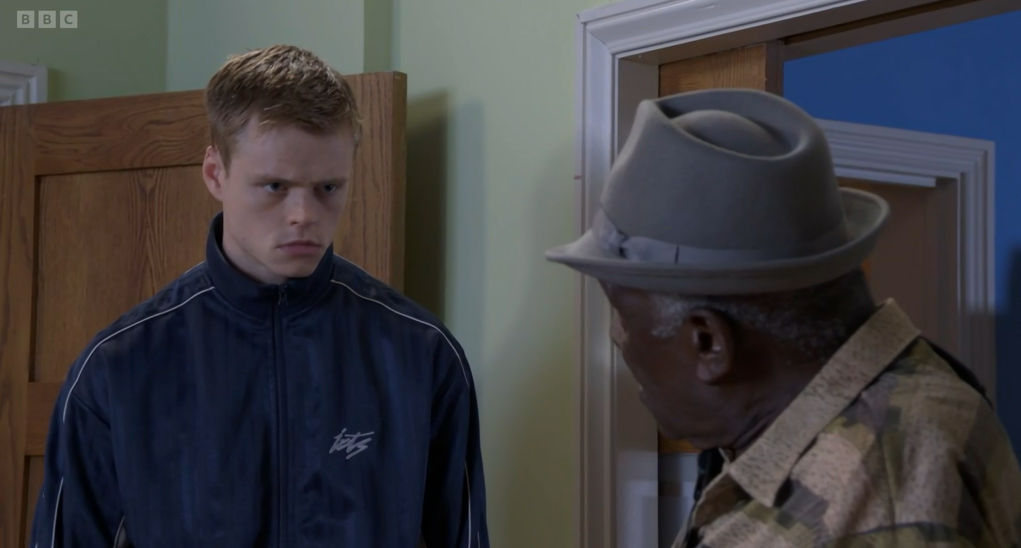 Eastender's Patrick stares in shock as Oscar tells him the truth