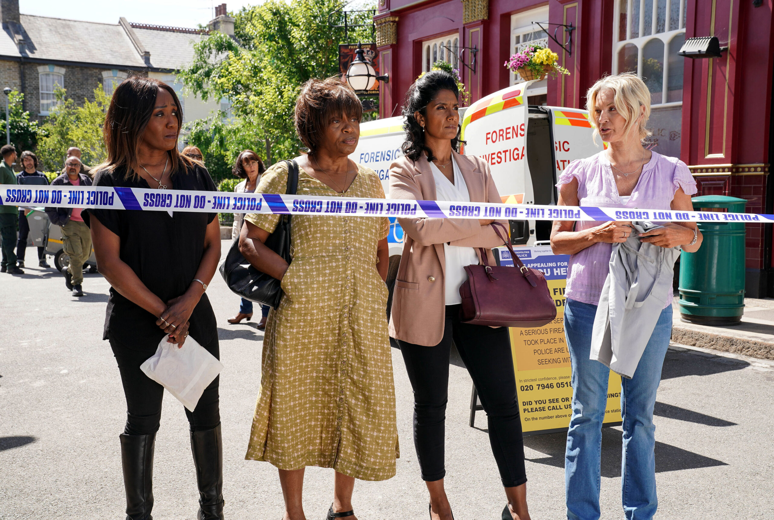 The residents of Walford line up behind police tape
