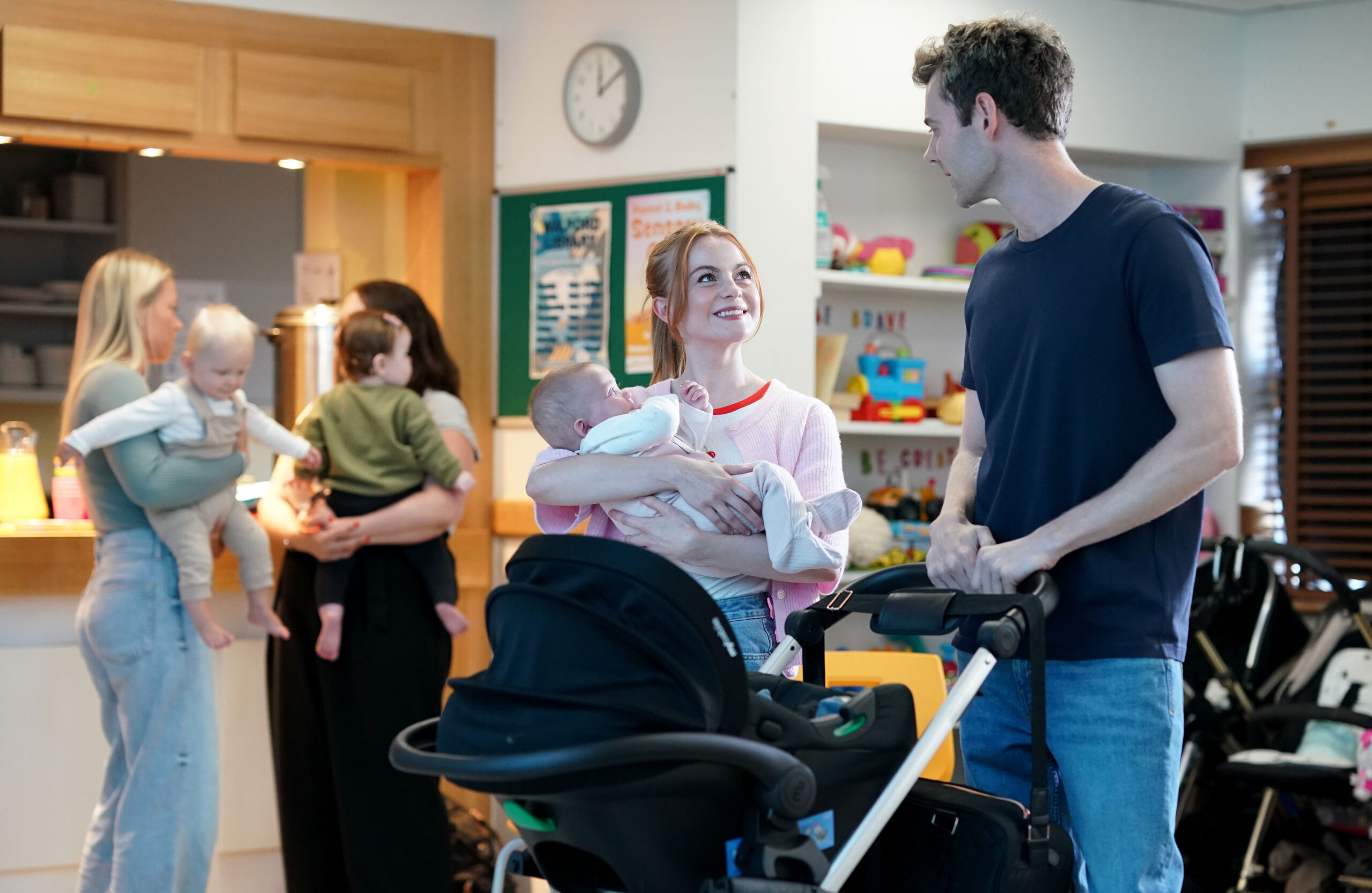 Peter talks to a smiling Demi on EastEnders, as she cradles her baby