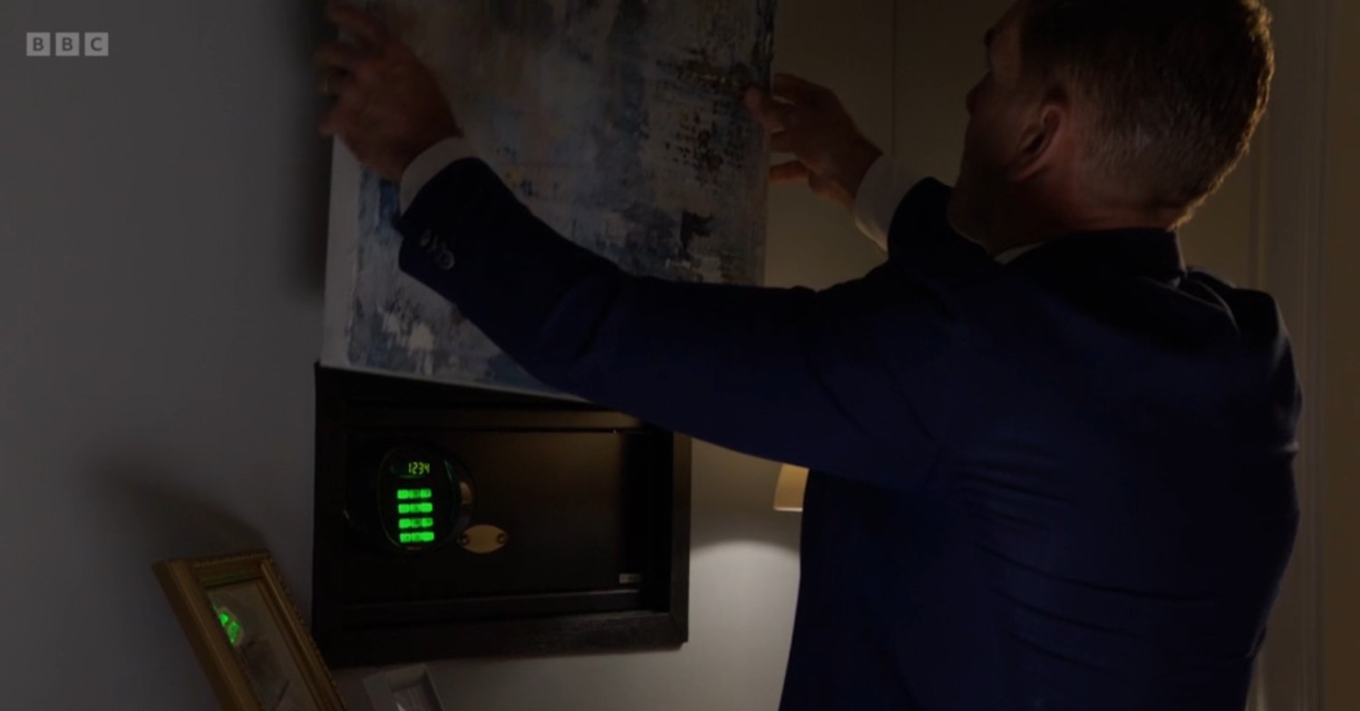 Jack covering up his safe with a picture on EastEnders