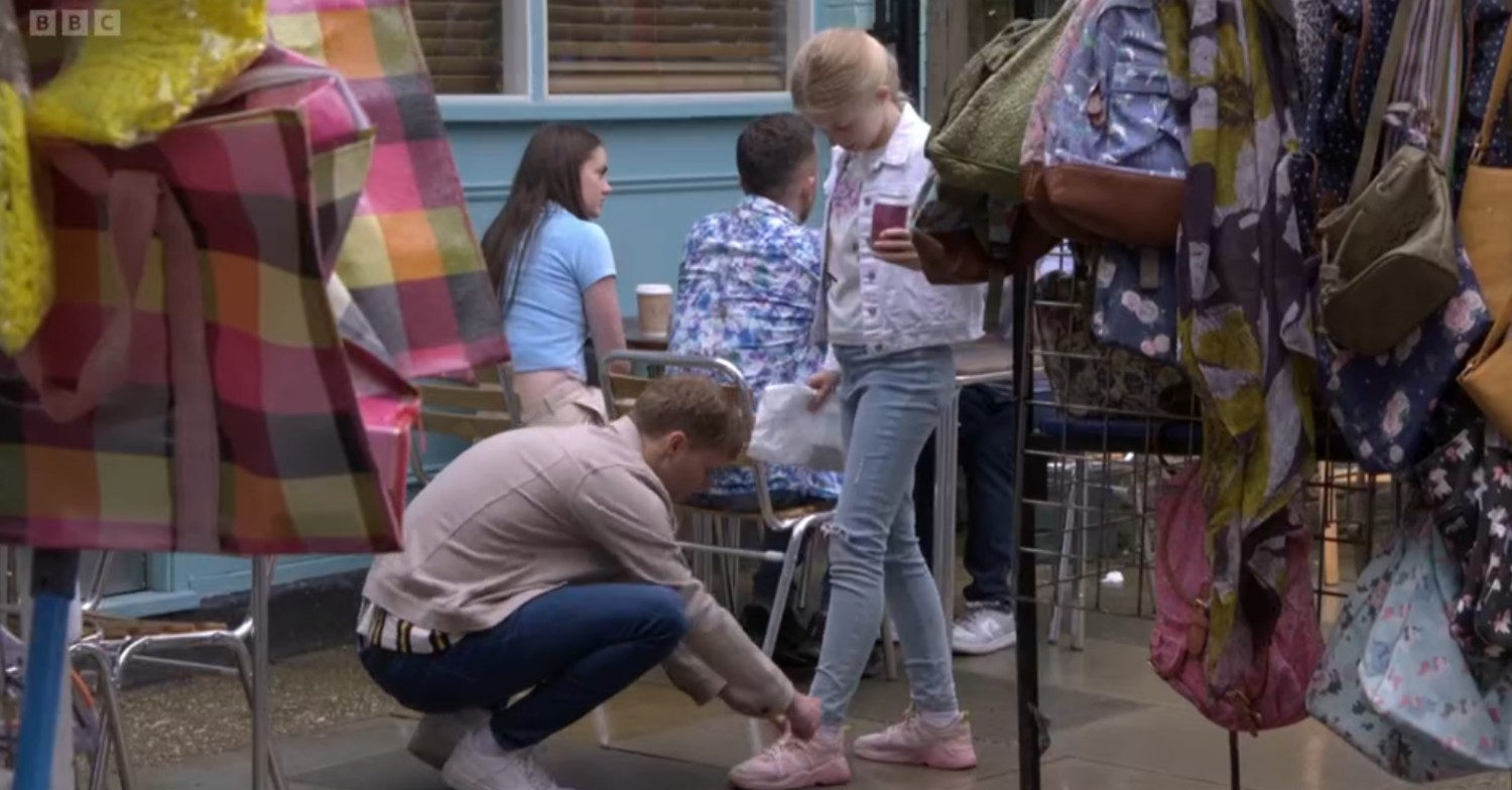Jay ties Lexi's shoelaces on EastEnders