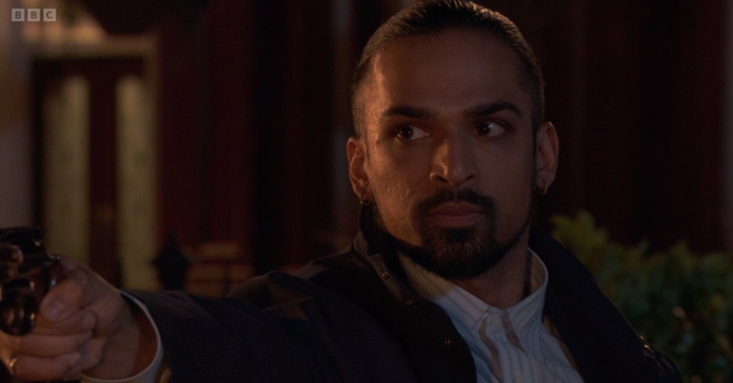 Ravi points a gun at Jack on EastEnders