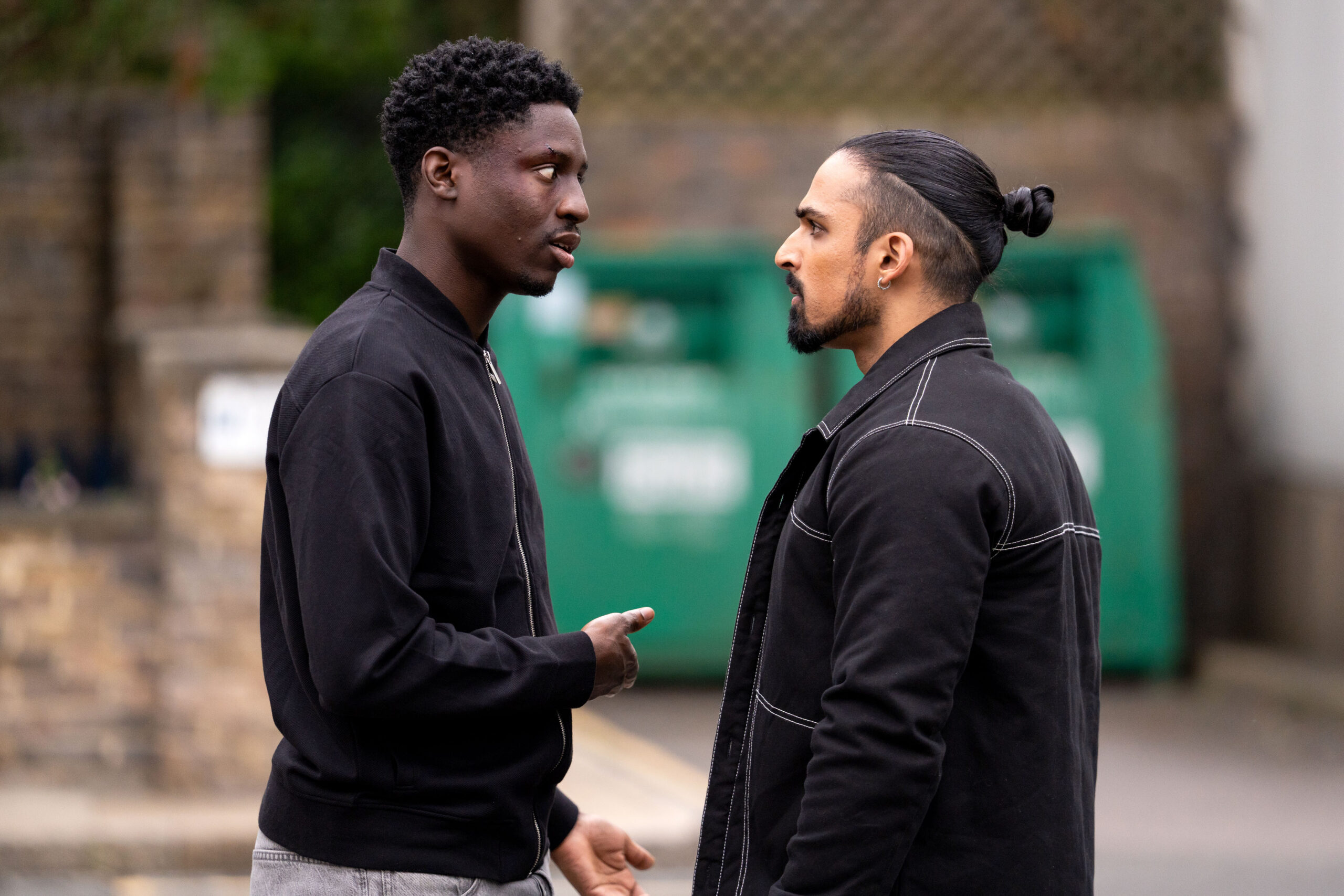 Ravi and Okie argue in the street on EastEnders