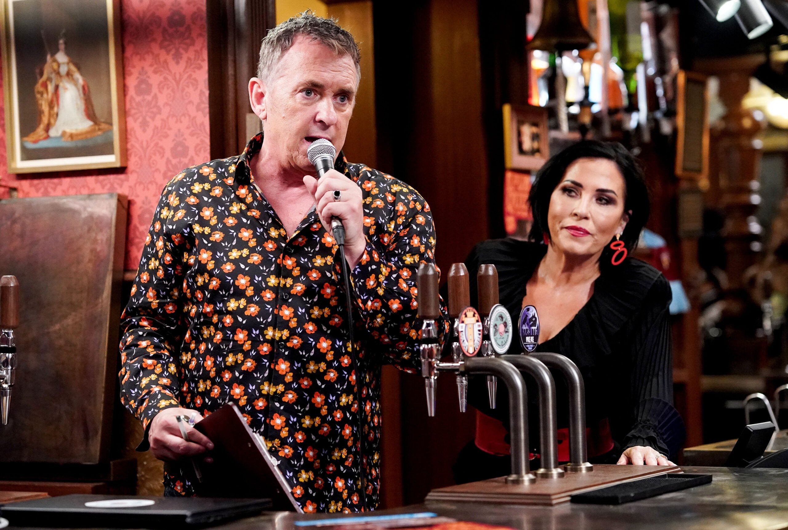 Kat and Alfie look worried behind the bar of The Vic