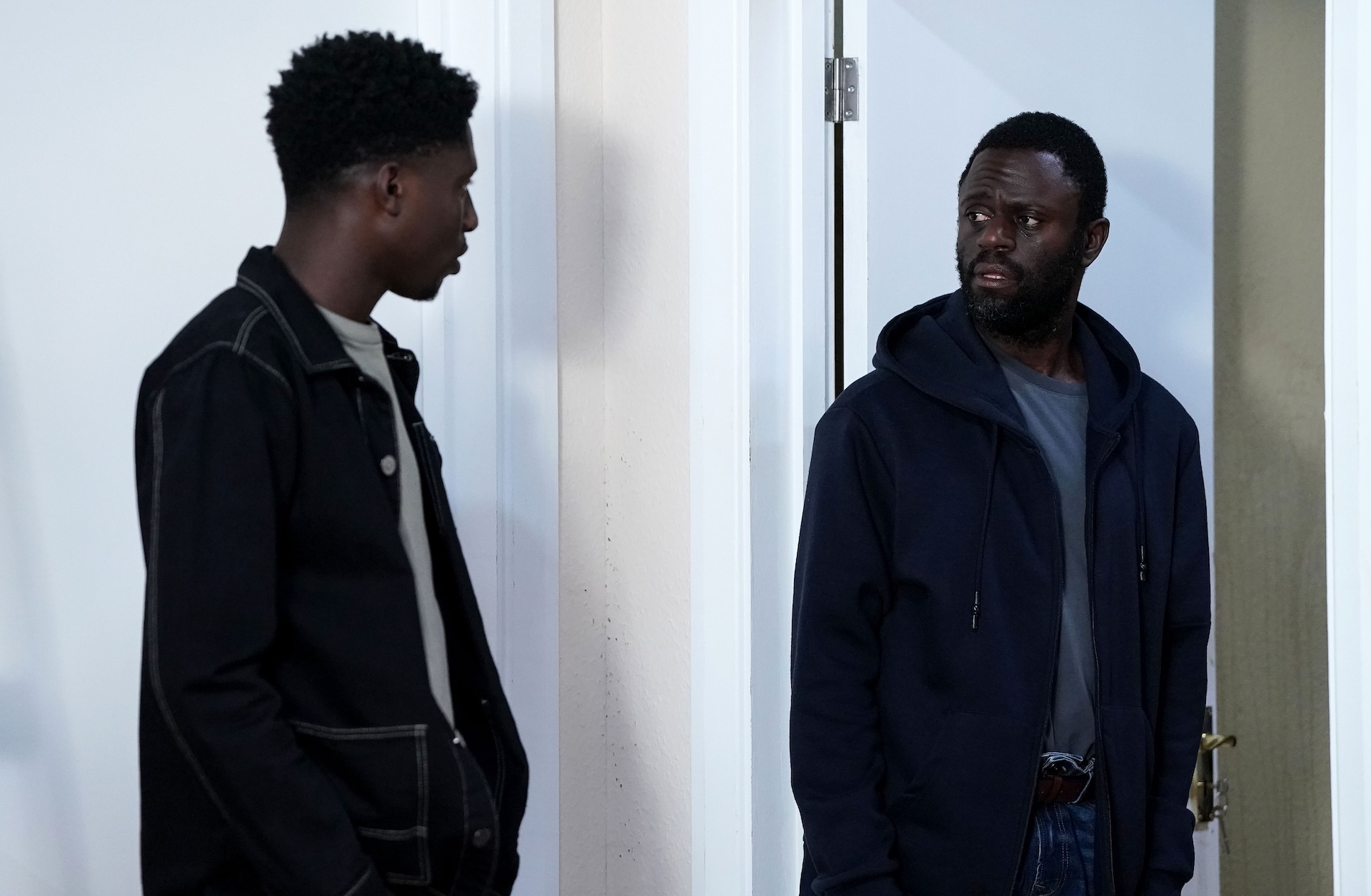 Kojo looks worried as Okie talks to him