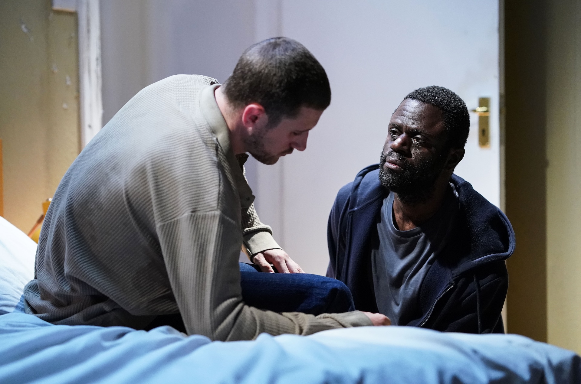 Kojo talks to Harry who is in bed and seriously ill