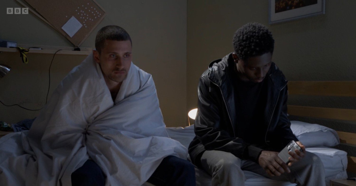 Okie sits with captive Harry on EastEnders