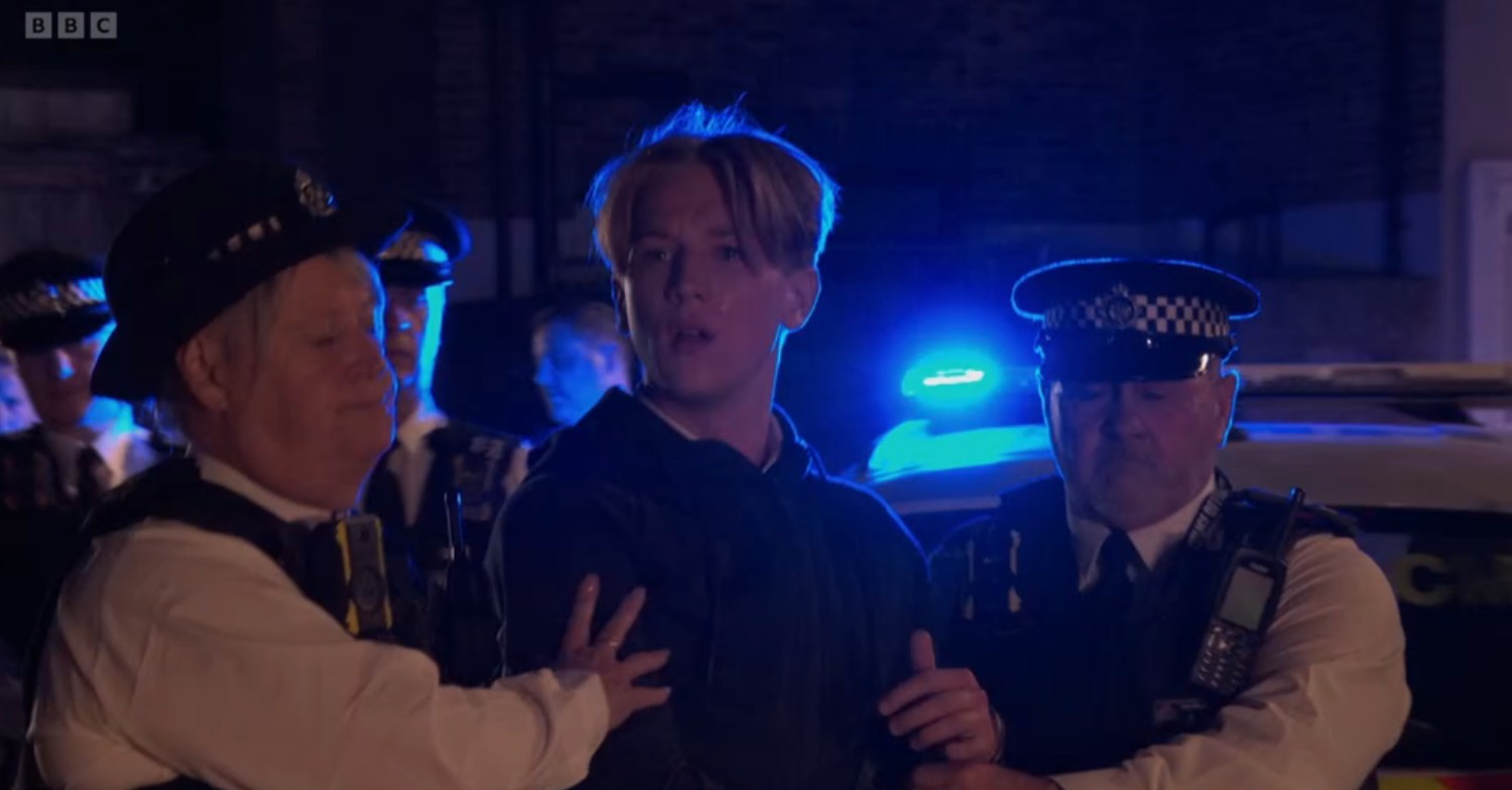 Joel being dragged away by the police in EastEnders