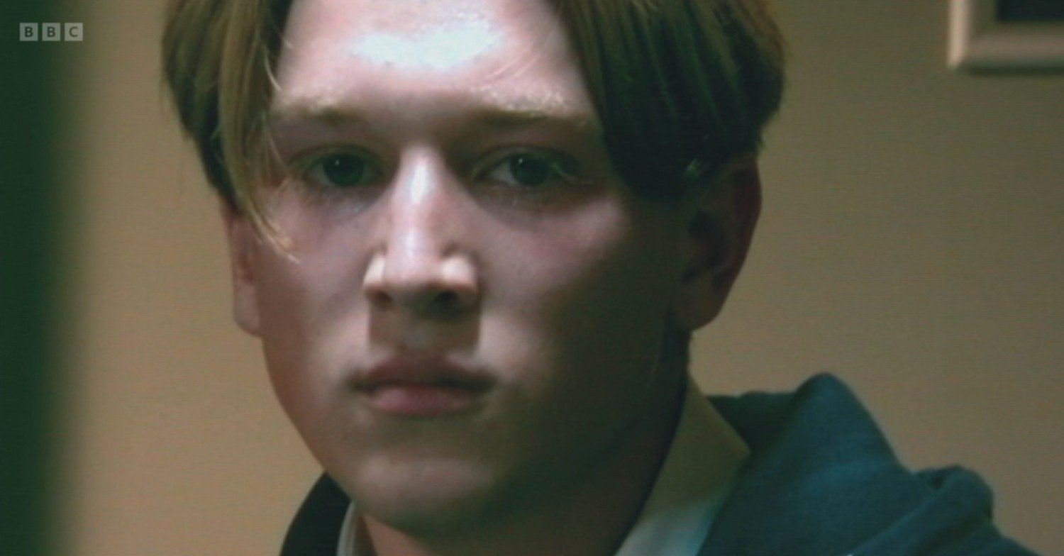 Joel glaring at the police camera on EastEnders tonight
