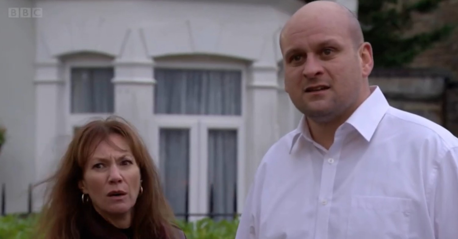 Stuart and Rainie look pained as they stand in the park on EastEnders