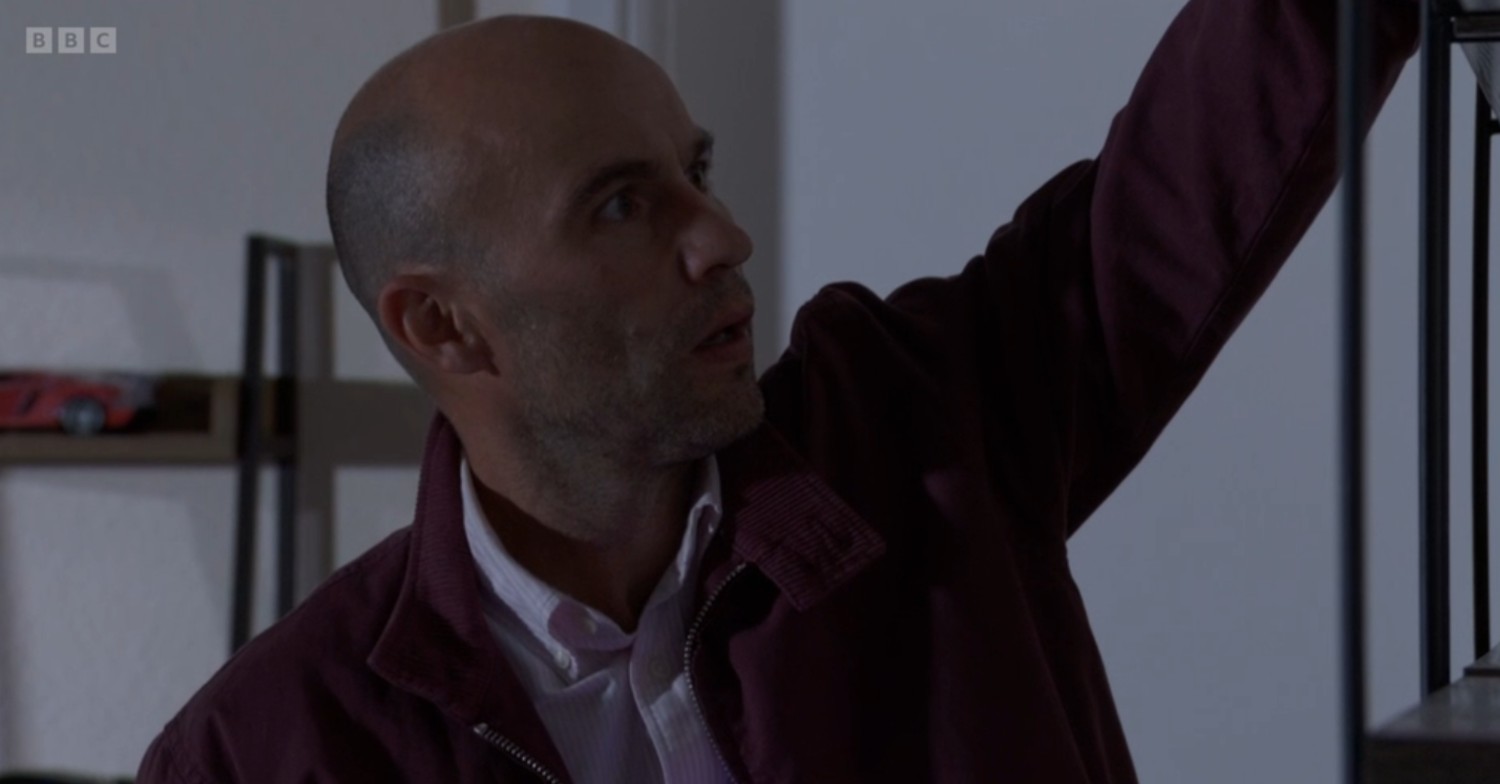Teddy hiding a camera in Kojo's flat