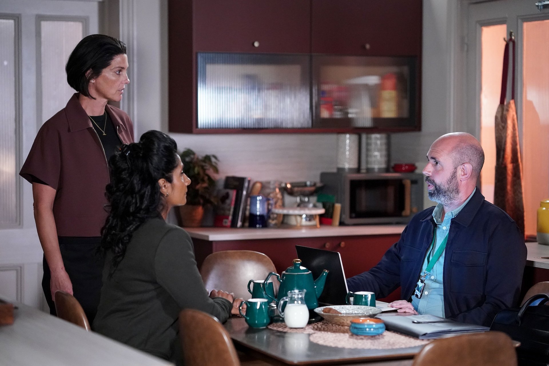 Suki and Eve talk with their adoption case worker