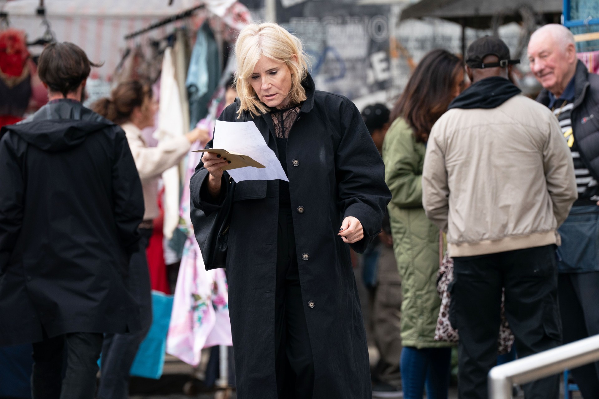 Cindy reading a piece of paper while looking suspicious
