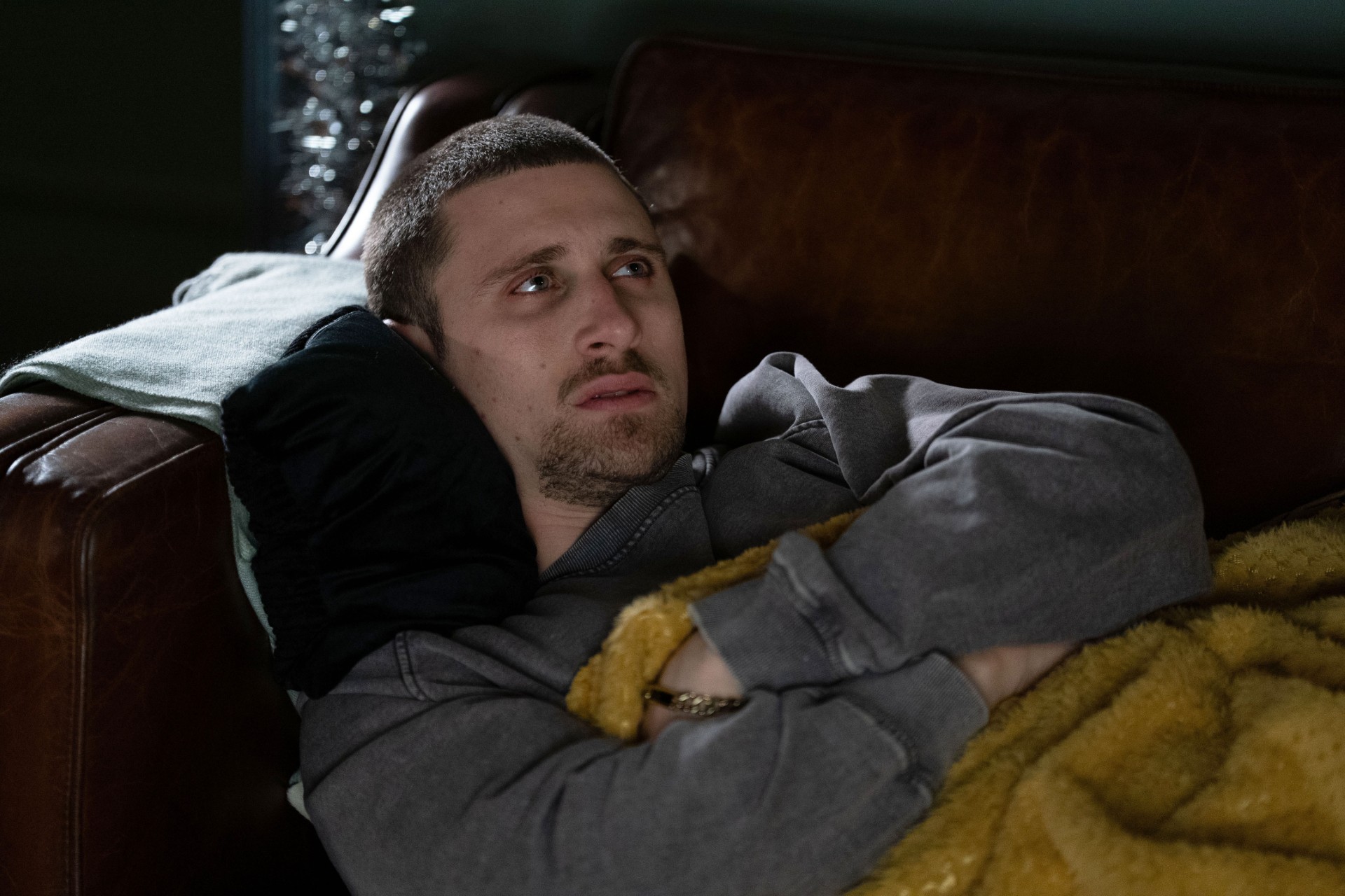 Harry looks distraught on the sofa