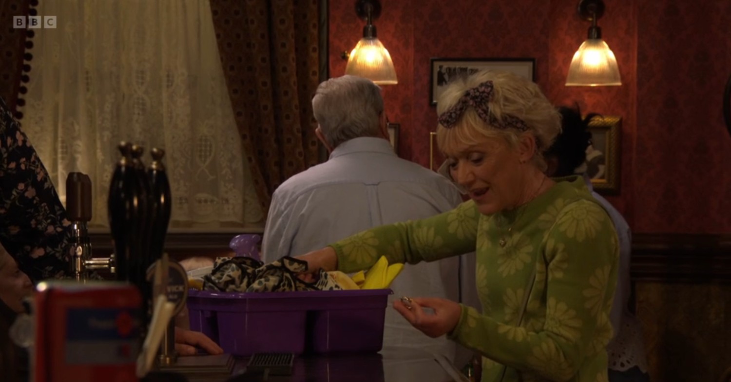 Jean in The Vic, looking excited