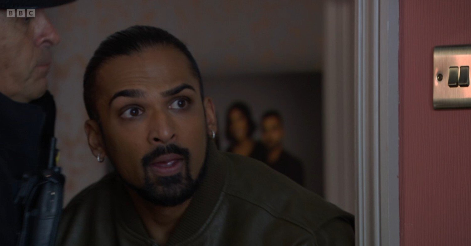 Ravi looks scared as he's dragged off by the police