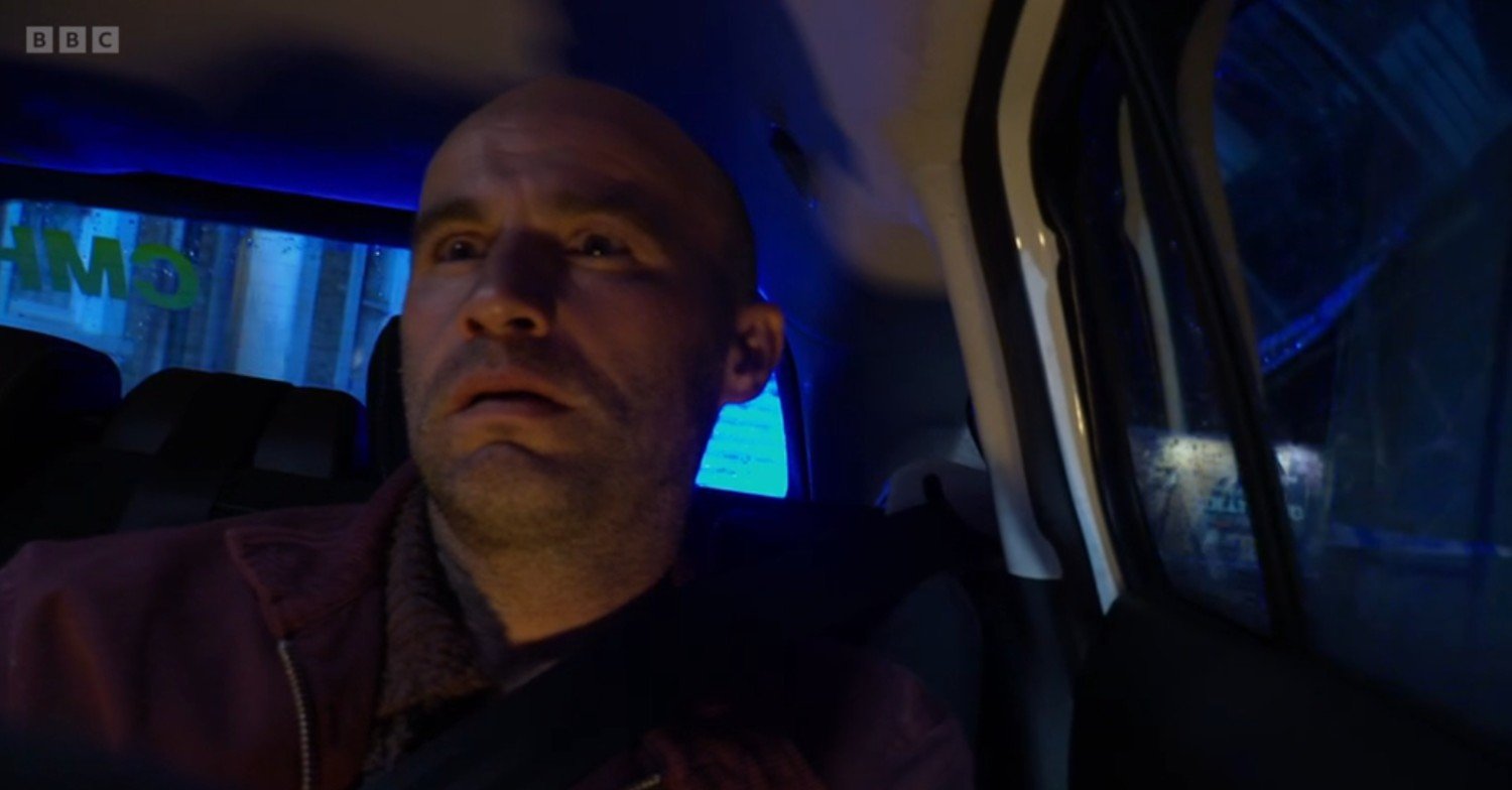 Teddy in the back of a police car on EastEnders