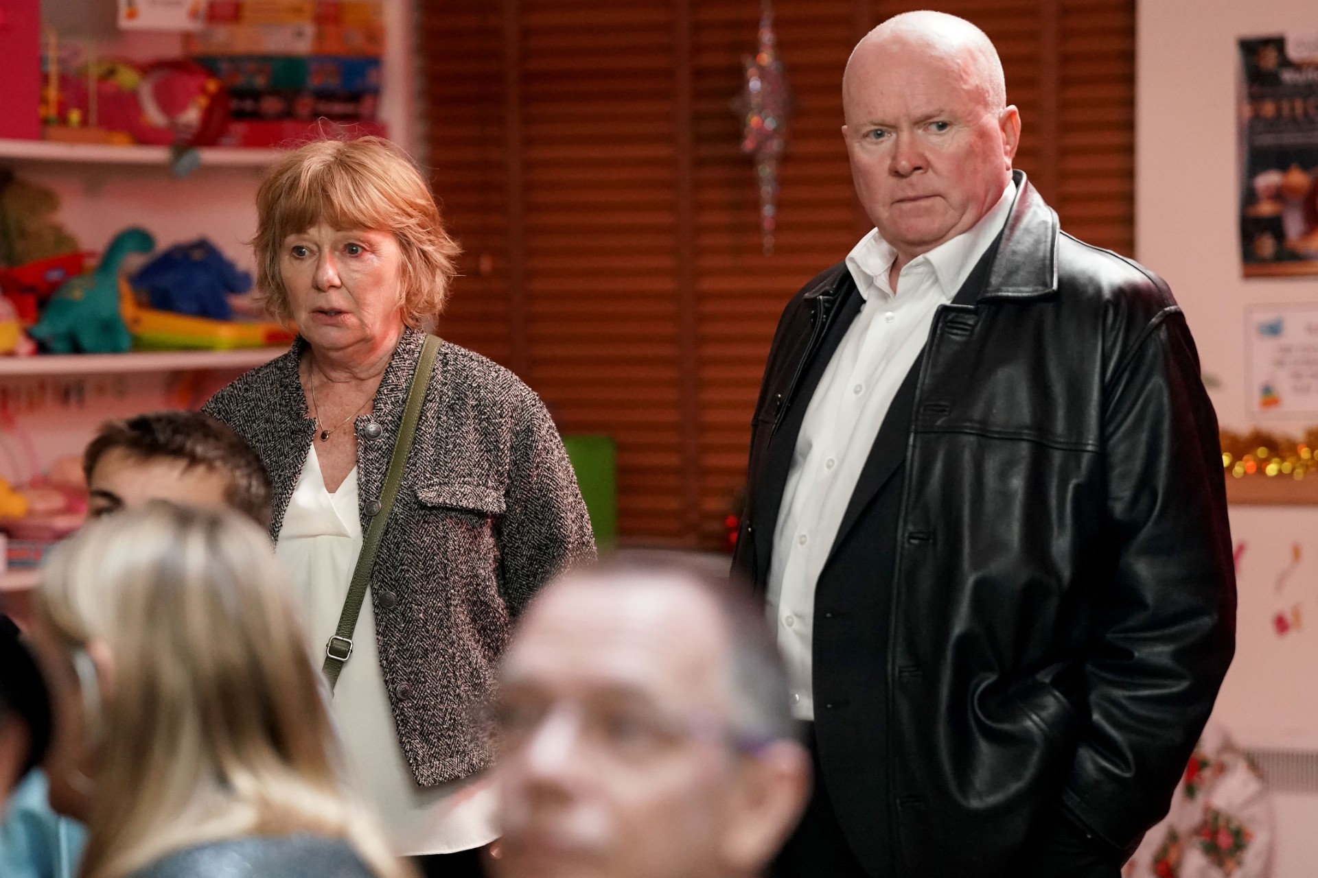 Phil; and Julie look worried on EastEnders