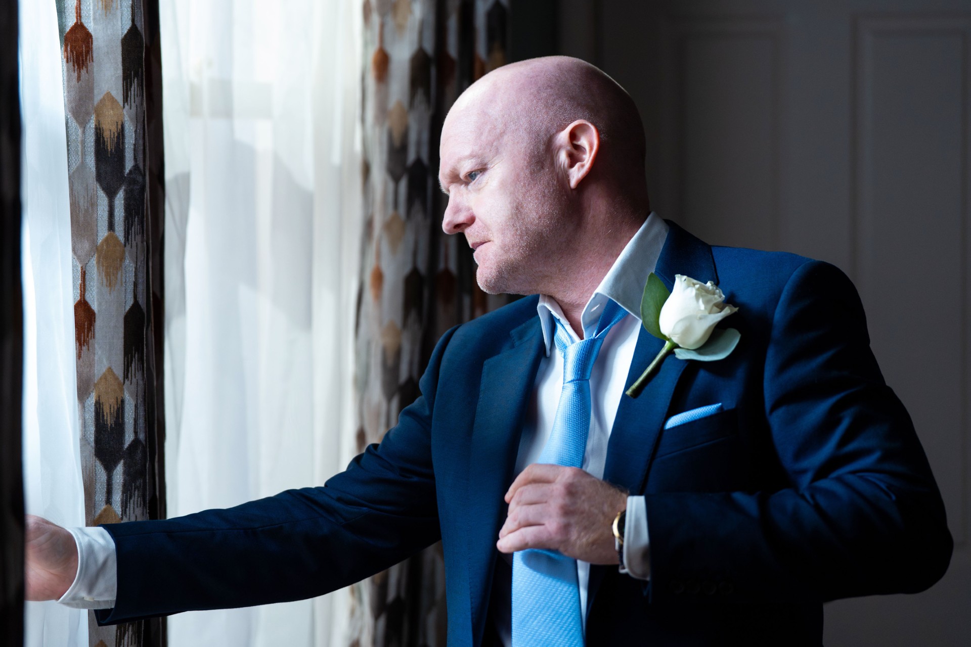 Max wearing a suit in an EastEnders flashforward