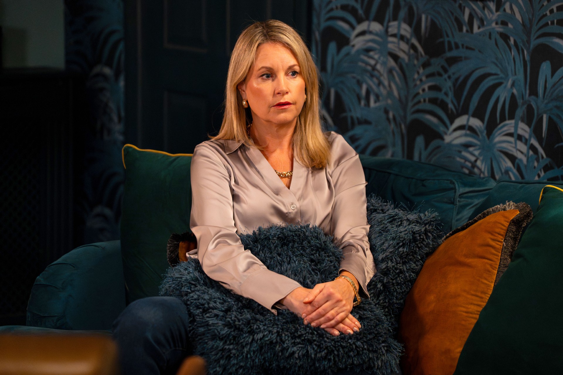 Sam looks worried as she sits in Phil's home