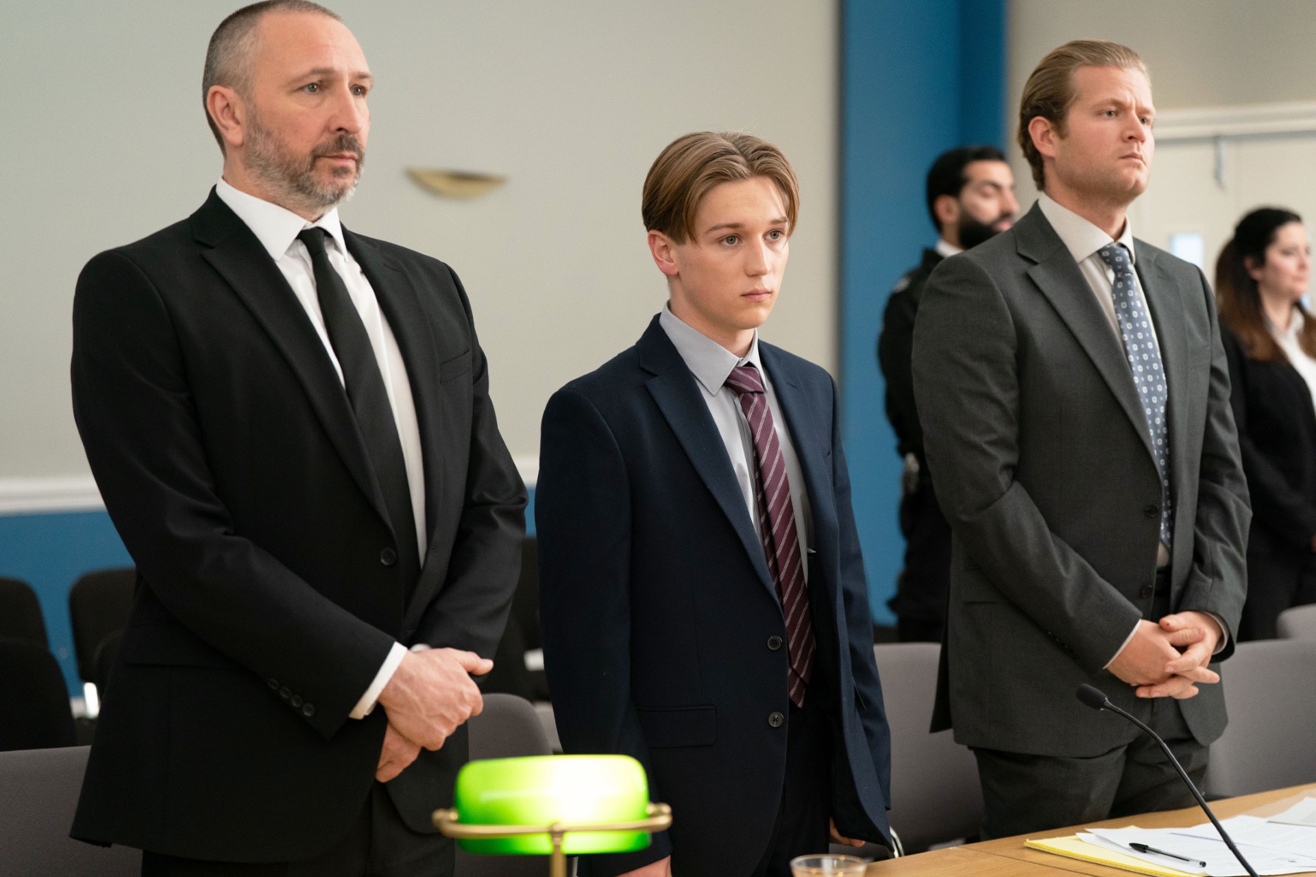 Joel and Ross in court with Joel's lawyer for his trial in EastEnders 