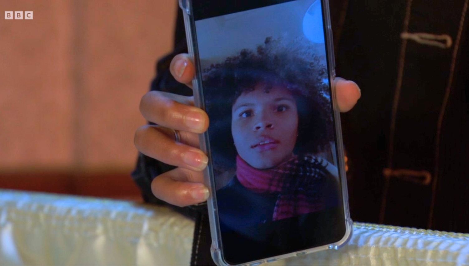 Jasmine's face pops up in a video on her phone