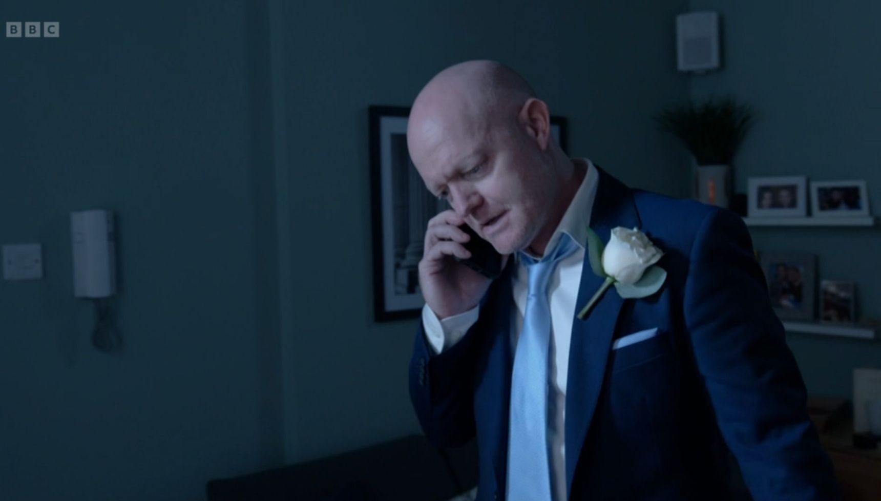 Max on the phone in his wedding suit